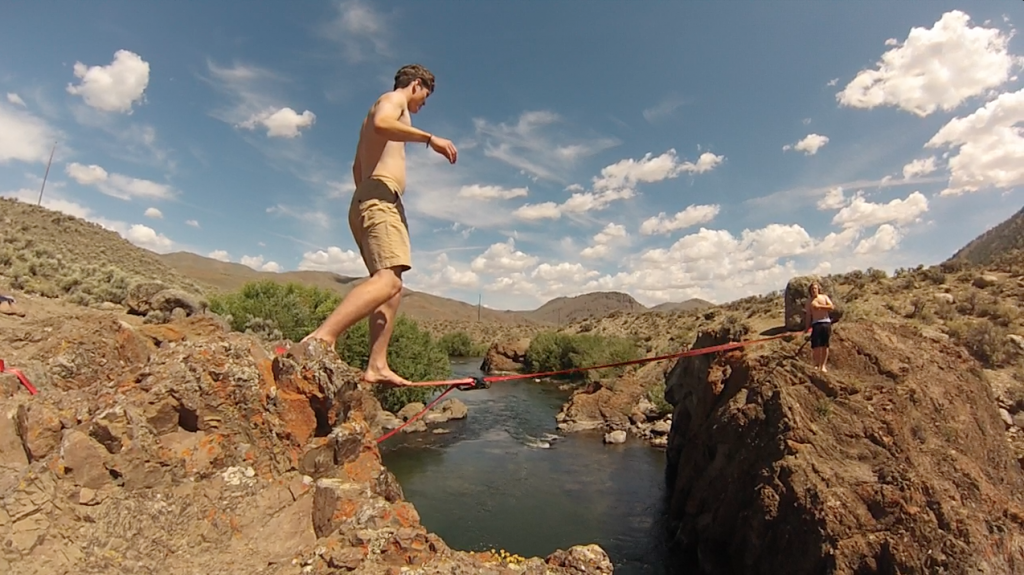 Slacklining over the river, between cliffs