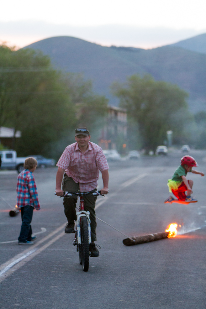 Otto Olson leaps burning logs. He has a number of talents and skills which will guarantee that traditions like Sheeptown will live on