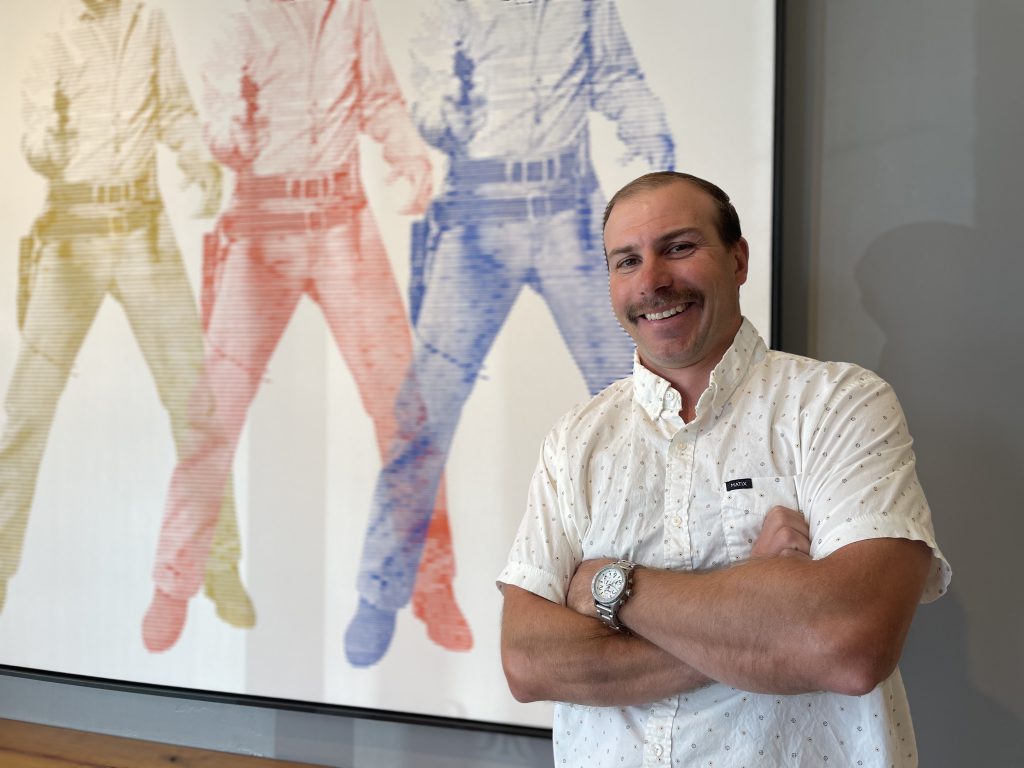 Rudi posing in front of his art